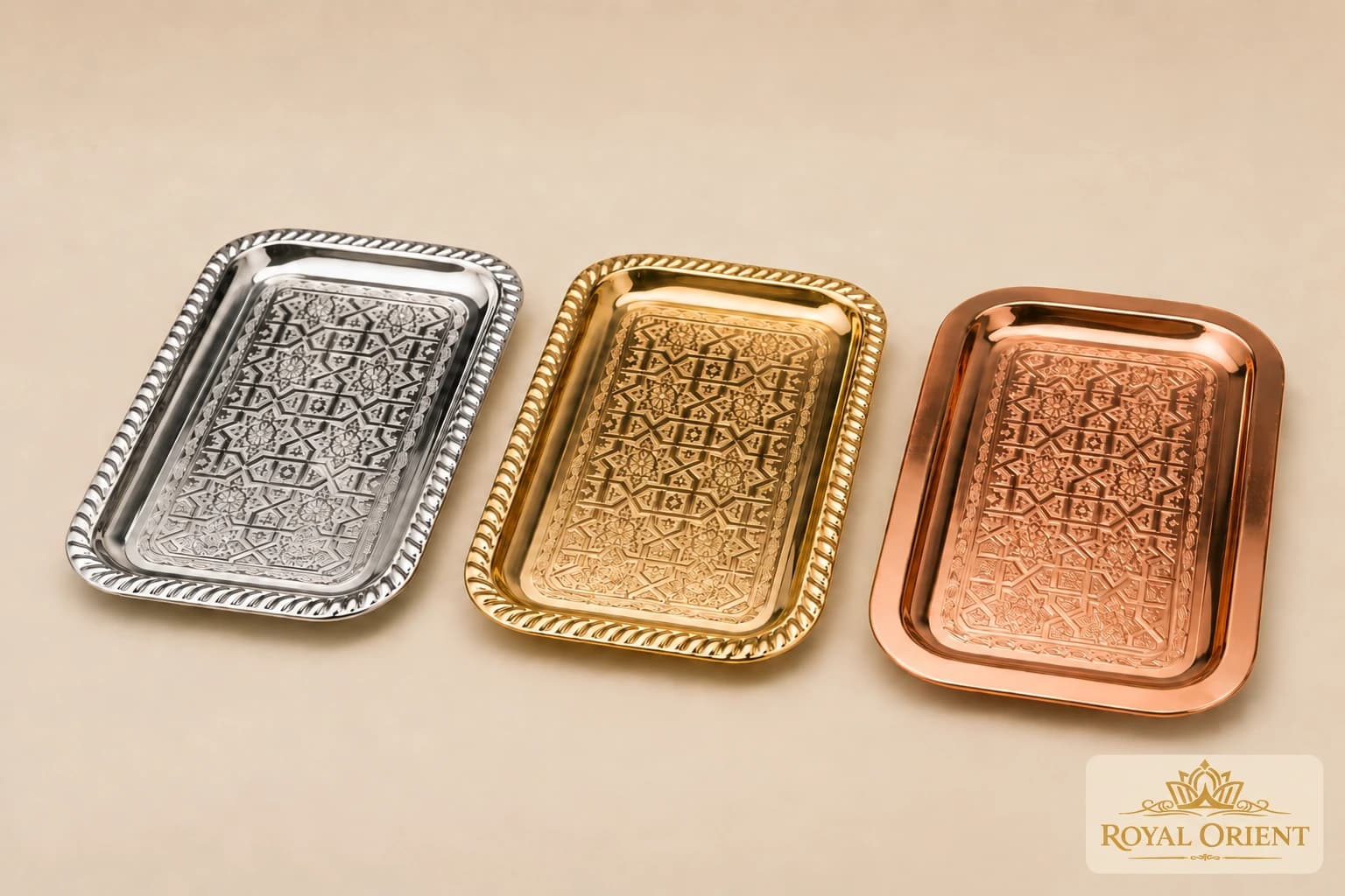 Silver, gold and copper rectangular trays with engraved patterns