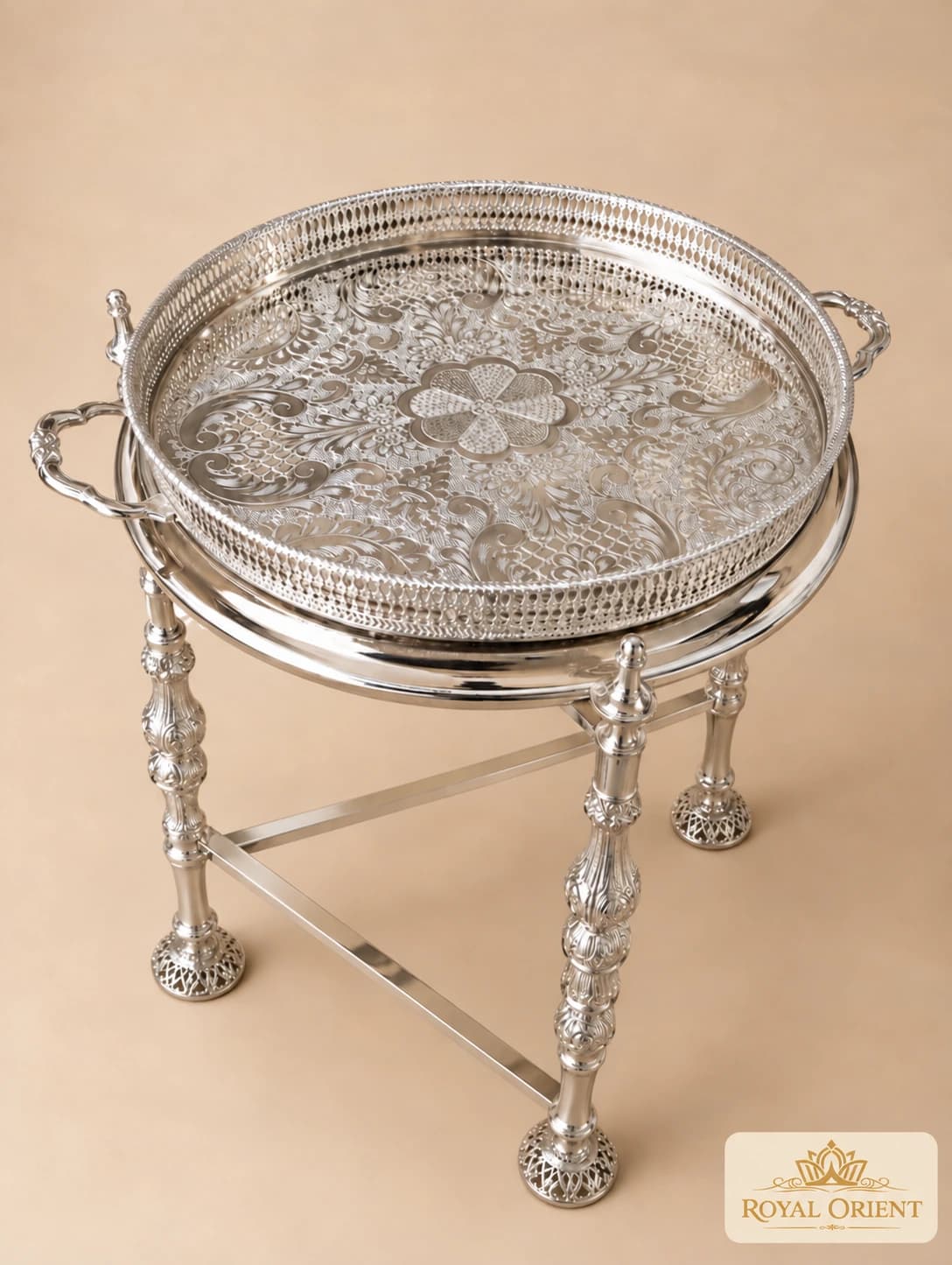 Engraved silver tray on a folding table stand